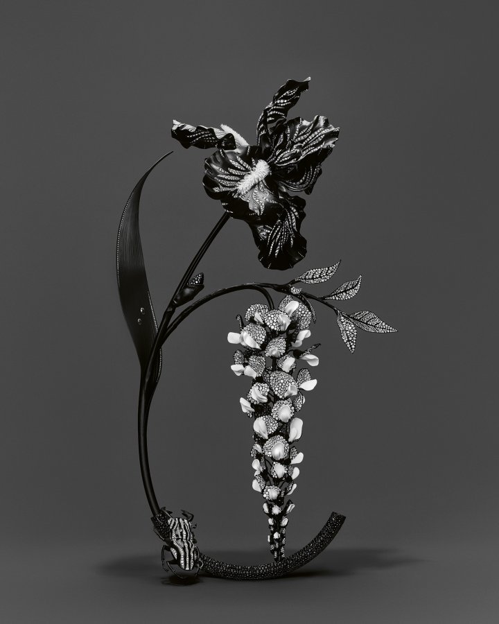 Boucheron, Composition N° 3: Iris, Wisteria, Stag Beetle. The iris offers different shades of black with matte finishes and shiny stripes. Diamonds set in white gold outline the surface and contours of the flower. To ensure that the wisteria is both light and sturdy, the craftsmen combined ceramic, titanium and aluminium. The body of the beetle is sculpted from titanium with white gold bands and pavé diamonds. The vase is made of aluminium and titanium and set with black spinels.