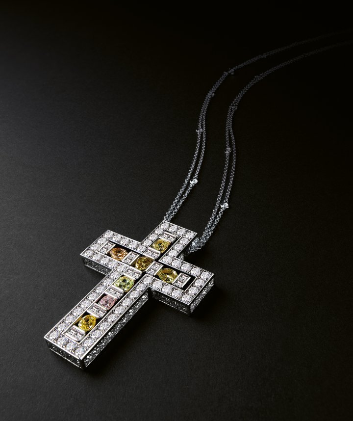 Belle Epoque Celebration cross in white gold, set with brilliant-cut diamonds and coloured diamonds in different cuts, alternating with kite-cut diamonds. ©Damiani