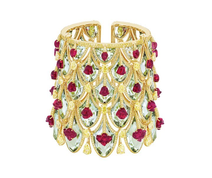 The Winter Roses cuff draws its inspiration from the Rose Gate of Jaipur's City Palace; a tribute to the Goddess Devi and the winter season. Carved rubellite flowers are set atop sea-green prasiolites, using the Kissing technique, while pendants of yellow diamonds are held beneath. ©Boghossian