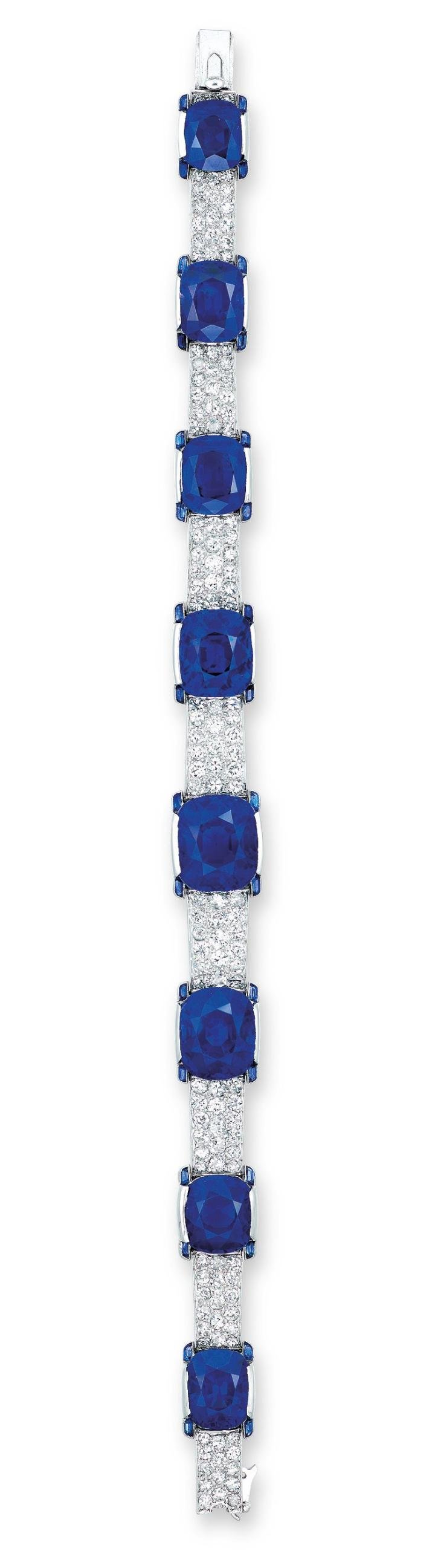  An exceptional Art Deco bracelet by Cartier sold by Christie's Hong Kong in 2016 for HKD 56,120,000 (USD 7,256,316) set with eight graduated cushion-shaped sapphires (10.53 to 3.38 car- ats) and four-stone diamond gallery, 1923, set in platinum.